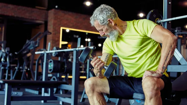Mature man lifting weights, representing renewed strength and vitality from testosterone replacement therapy