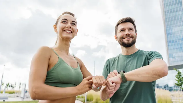 Man and woman smiling together outdoors after a workout, representing hormone optimization for both men and women